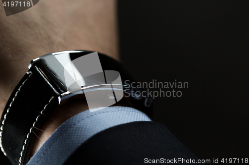 Image of close up of businessman hand with smart watch