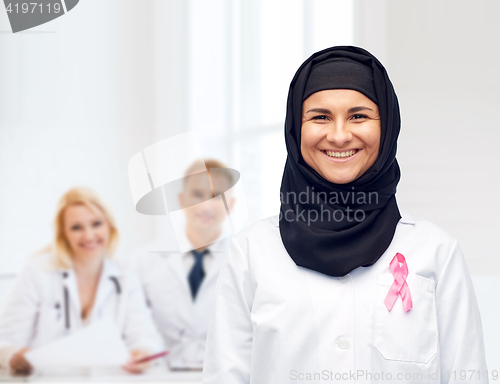 Image of muslim doctor with breast cancer awareness ribbon