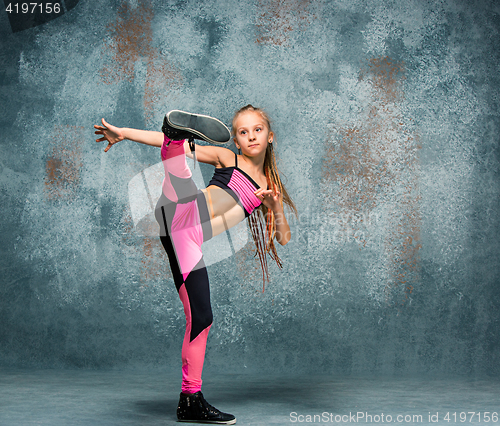 Image of Young girl break dancing on wall background.