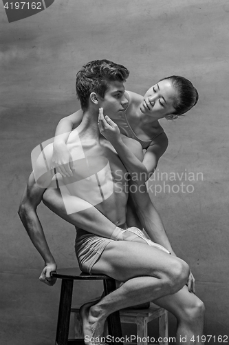 Image of Couple of ballet dancers posing over gray background