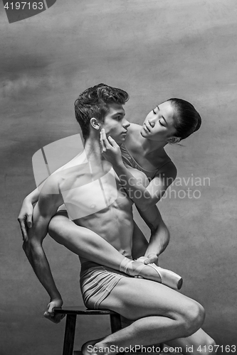 Image of Couple of ballet dancers posing over gray background