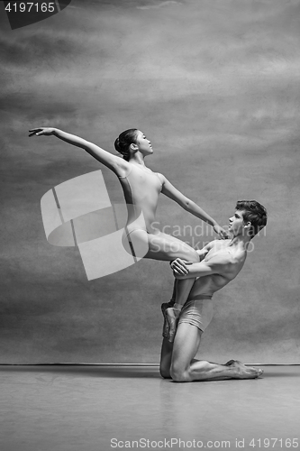 Image of Couple of ballet dancers posing over gray background