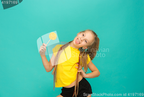 Image of The teen girl with colorful lollipop on a blue background