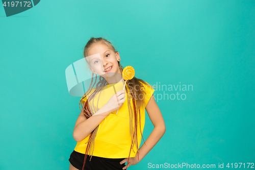 Image of The teen girl with colorful lollipop on a blue background