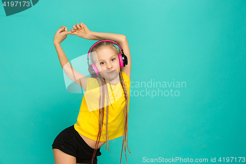 Image of The attractive girl with headphones on blue background