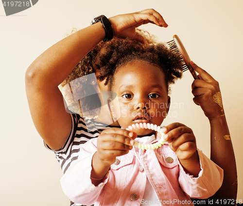 Image of adorable sweet young afro-american mother with cute little daughter, hanging at home, having fun playing smiling, lifestyle people concept, happy smiling modern family 