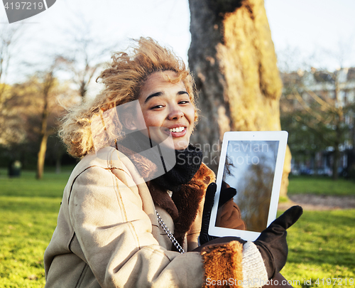 Image of young cute blond african american girl student holding tablet and smiling, lifestyle people concept 