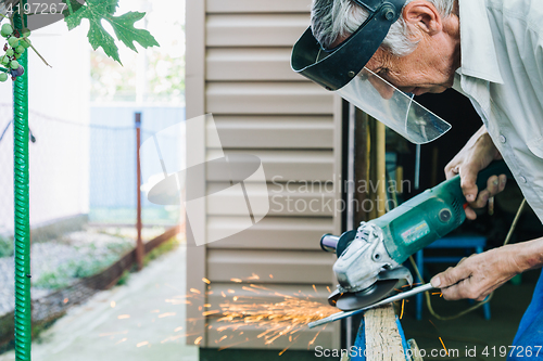 Image of Close-up of workman working with iron