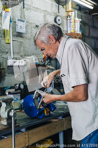 Image of Close-up of workman working with iron