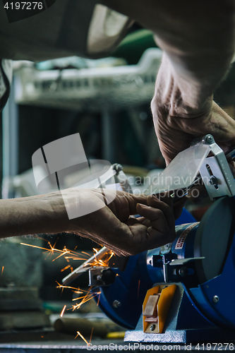 Image of Close-up of workman working with iron