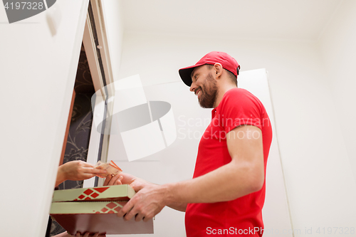 Image of man delivering pizza to customer and taking money