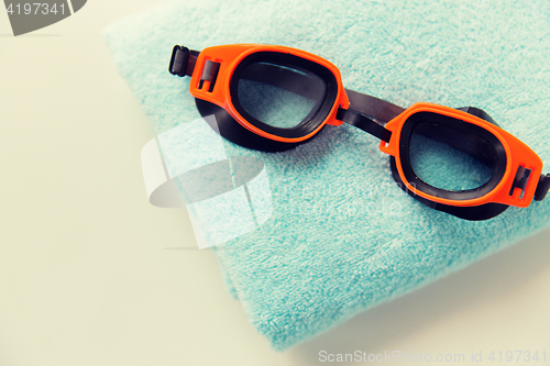 Image of close up of swimming goggles and towel