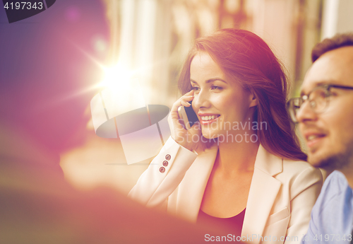 Image of businesswoman calling on smartphone at office