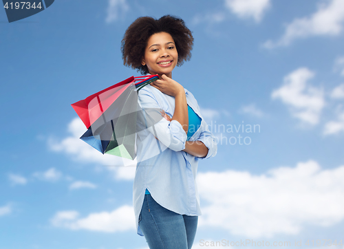 Image of smiling afro american woman with shopping bags