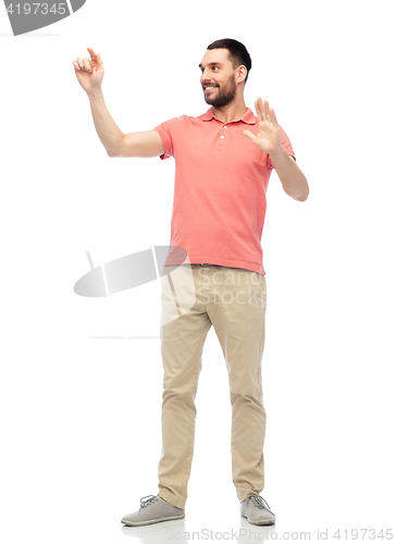 Image of happy man touching something imaginary