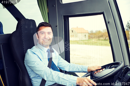 Image of happy driver driving intercity bus