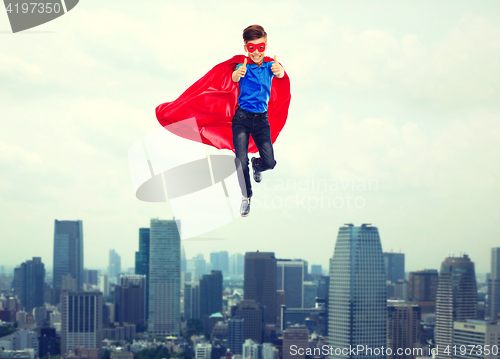 Image of boy in super hero cape and mask showing thumbs up