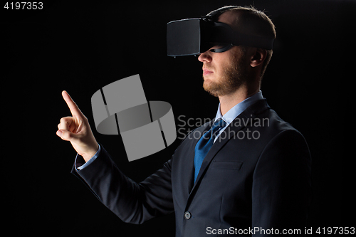 Image of businessman in virtual reality glasses or headset