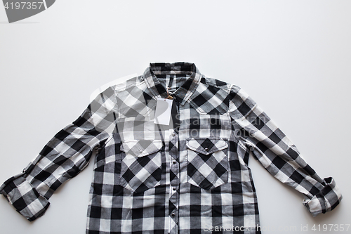 Image of close up of checkered shirt on white background
