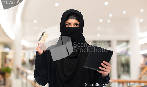 Image of woman in hijab with tablet pc and credit card
