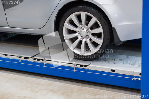 Image of car on lift at repair station