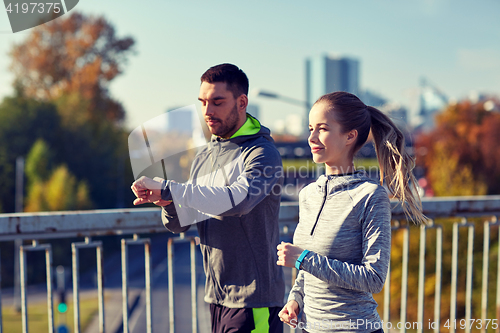 Image of couple running over city highway bridge