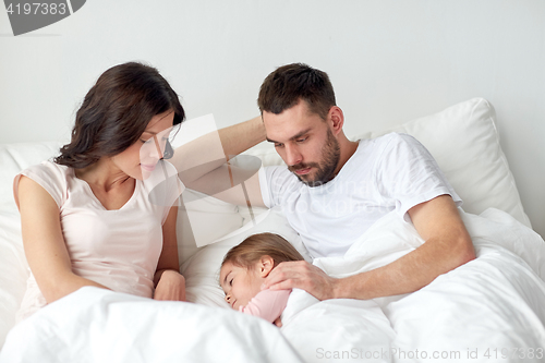 Image of family sleeping in bed at home