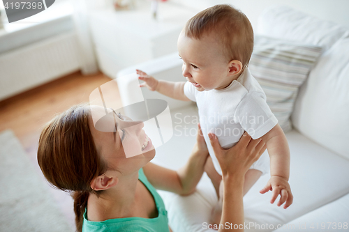 Image of happy young mother with little baby at home