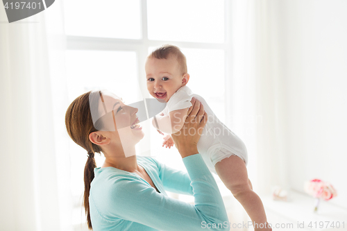 Image of happy young mother with little baby at home