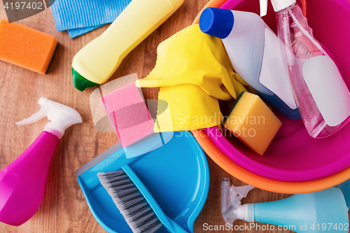 Image of basin with cleaning stuff on wooden floor