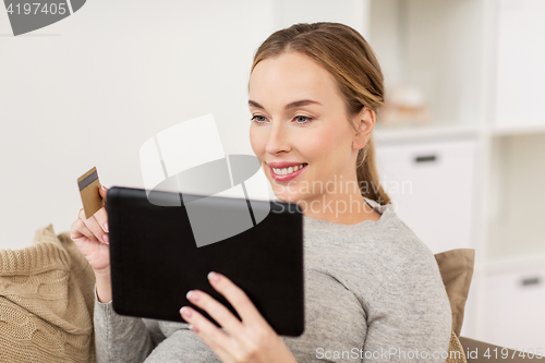 Image of happy woman with tablet pc and credit card