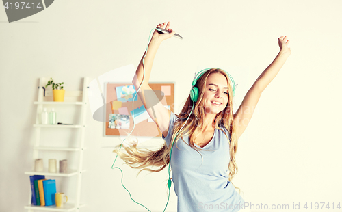 Image of happy woman in headphones ihaving fun at home