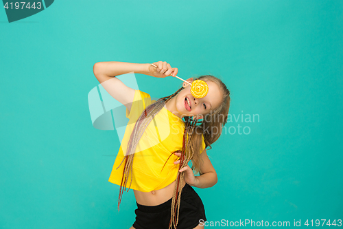 Image of The teen girl with colorful lollipop on a blue background