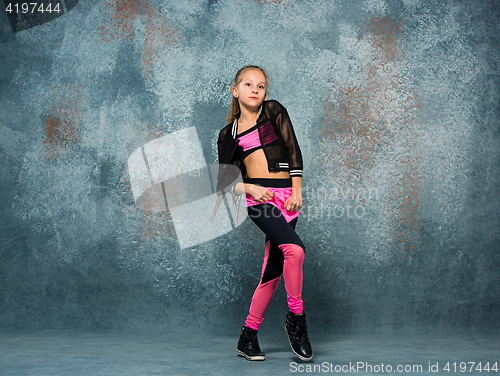 Image of Young girl break dancing on wall background.