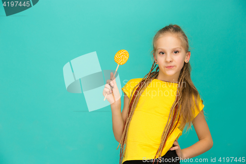 Image of The teen girl with colorful lollipop on a blue background