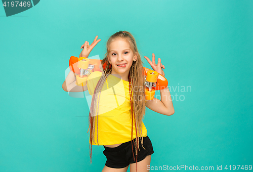 Image of Pretty skater girl holding skateboard