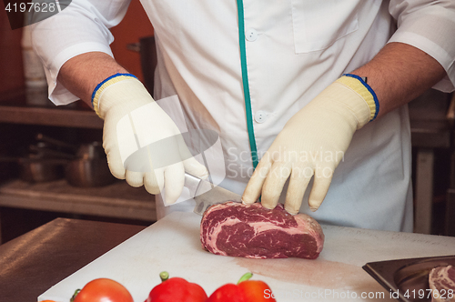 Image of Chef cutting meat