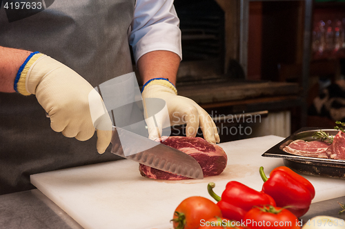 Image of Chef cutting meat