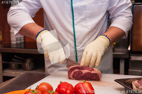 Image of Chef cutting meat