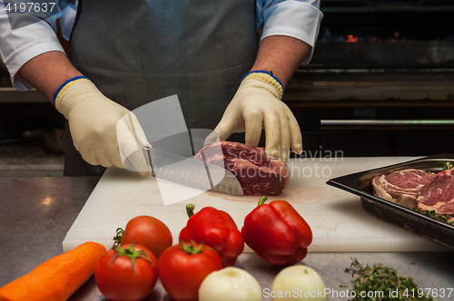 Image of Chef cutting meat