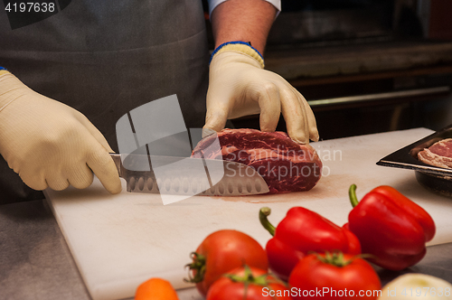 Image of Chef cutting meat