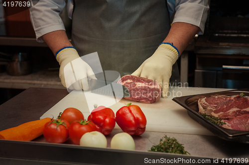 Image of Chef cutting meat