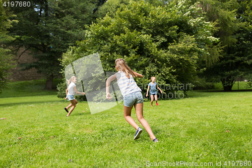 Image of group of happy kids or friends playing outdoors