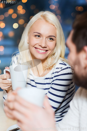 Image of happy couple meeting and drinking tea or coffee