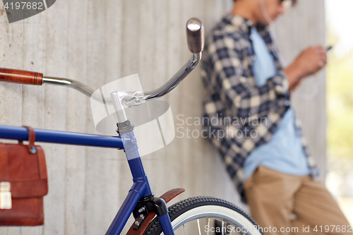 Image of man with fixed gear bicycle on street