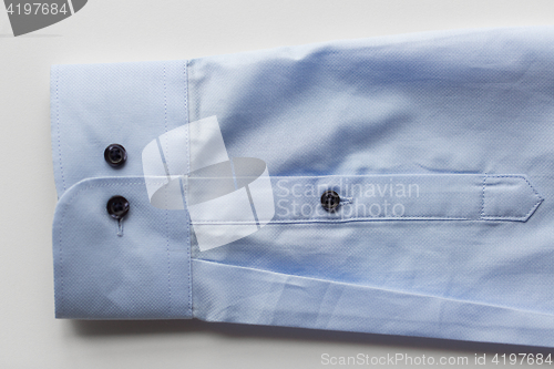 Image of close up of blue shirt sleeve