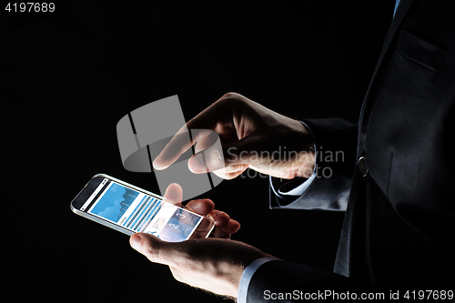 Image of close up of businessman with charts on smartphone