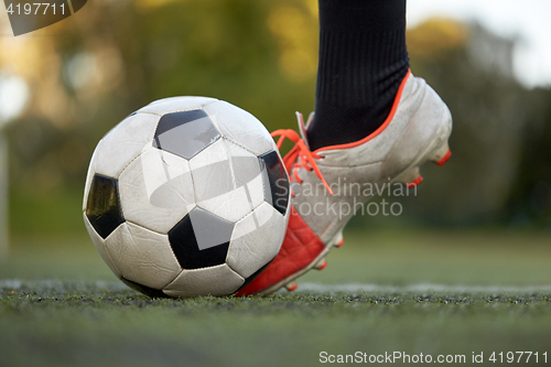 Image of soccer player playing with ball on football field