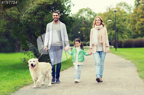 Image of happy family with labrador retriever dog in park