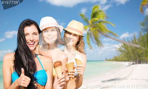 Image of group of happy young women with ice cream on beach